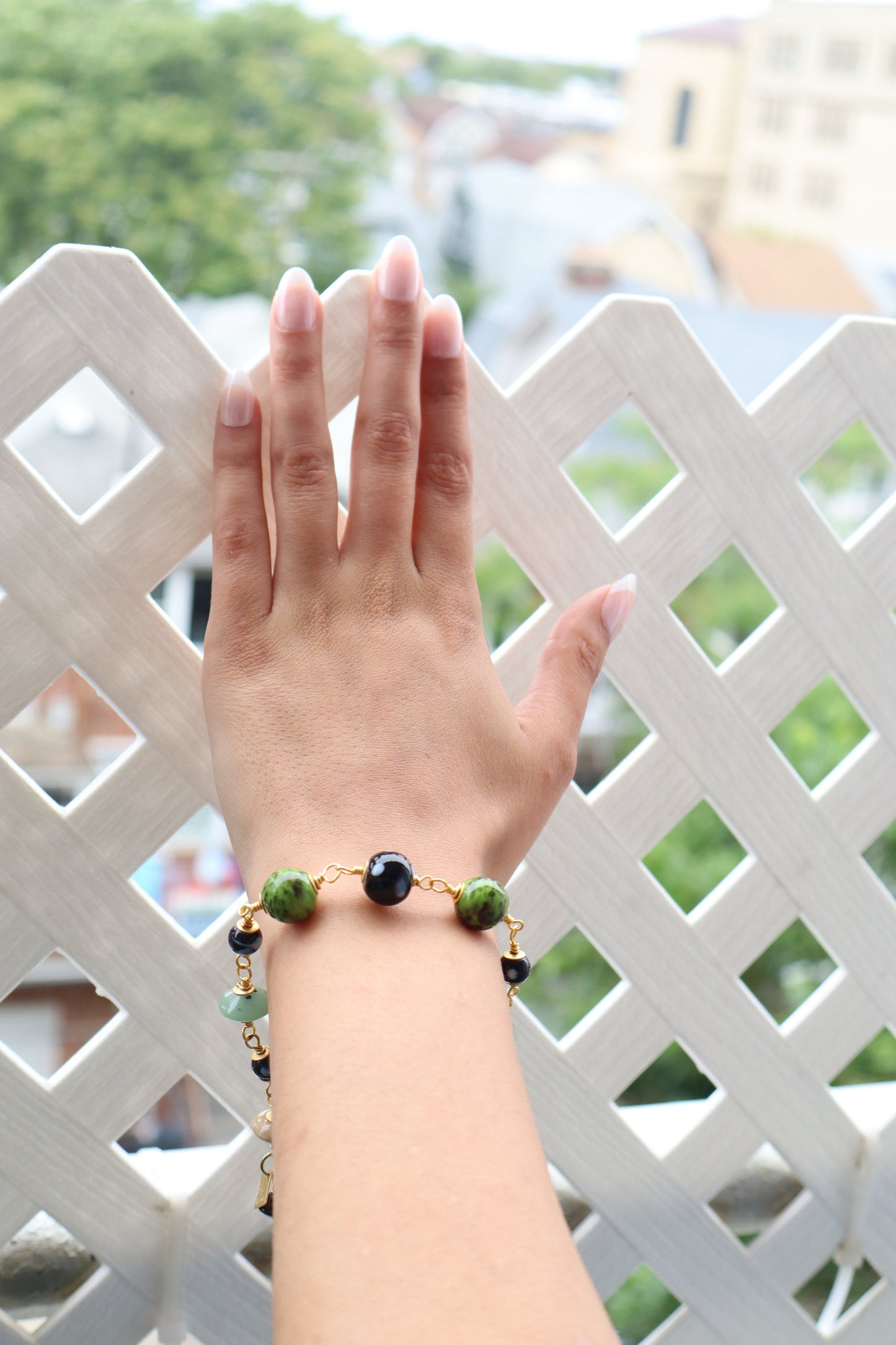 Hand wearing a bracelet with a decorative background