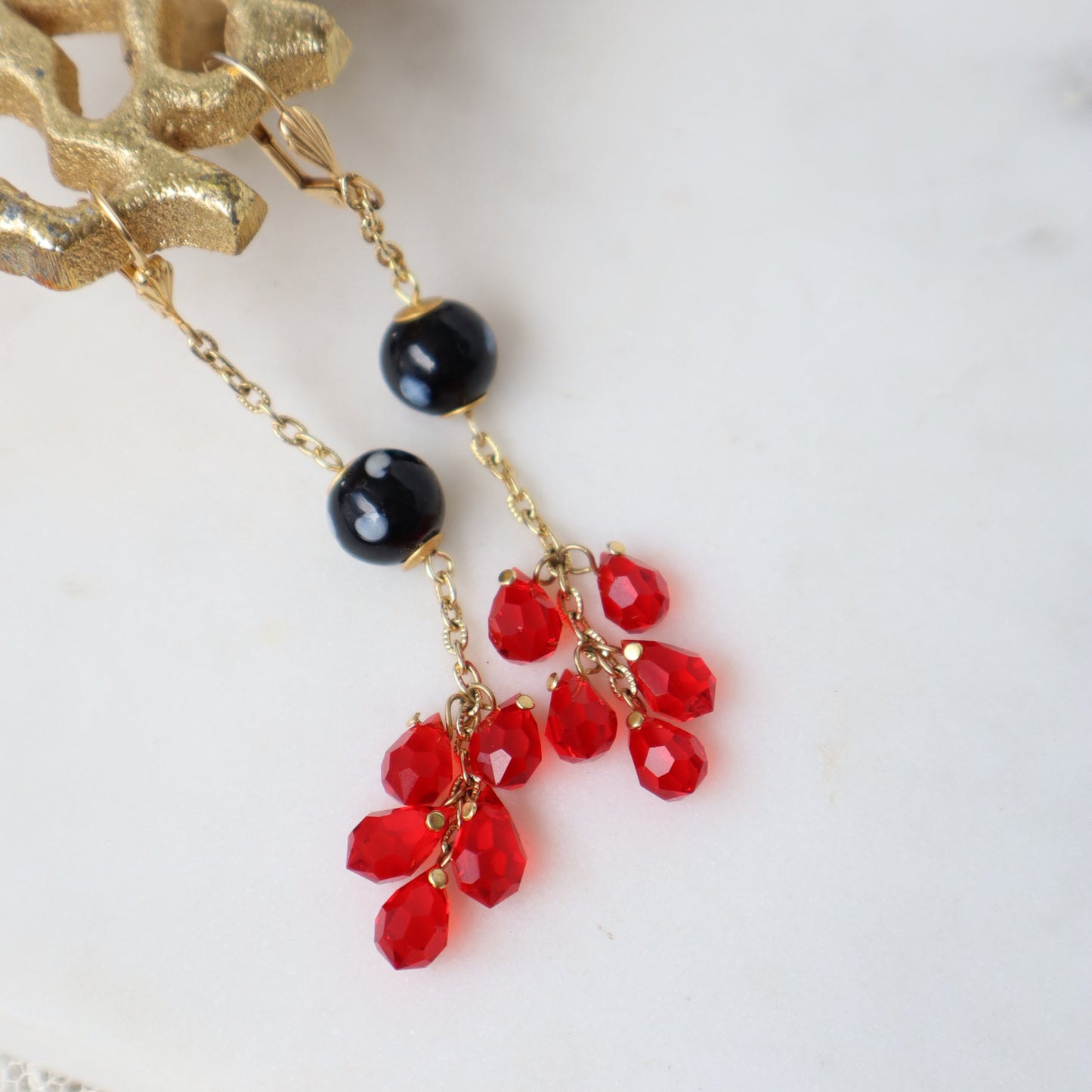 Earrings with red and black beads on a white background