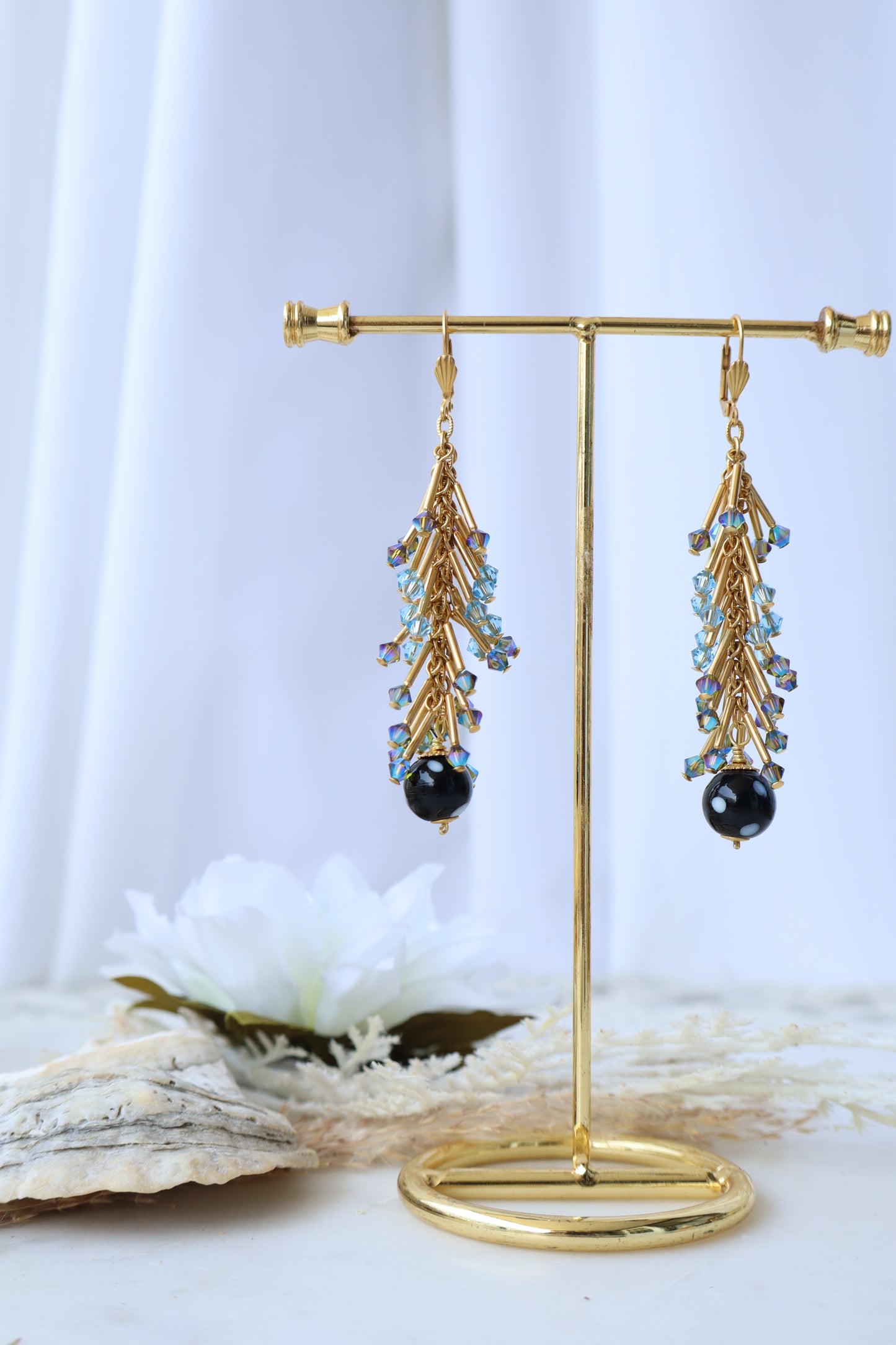 Gold brooch with gemstones on a white background