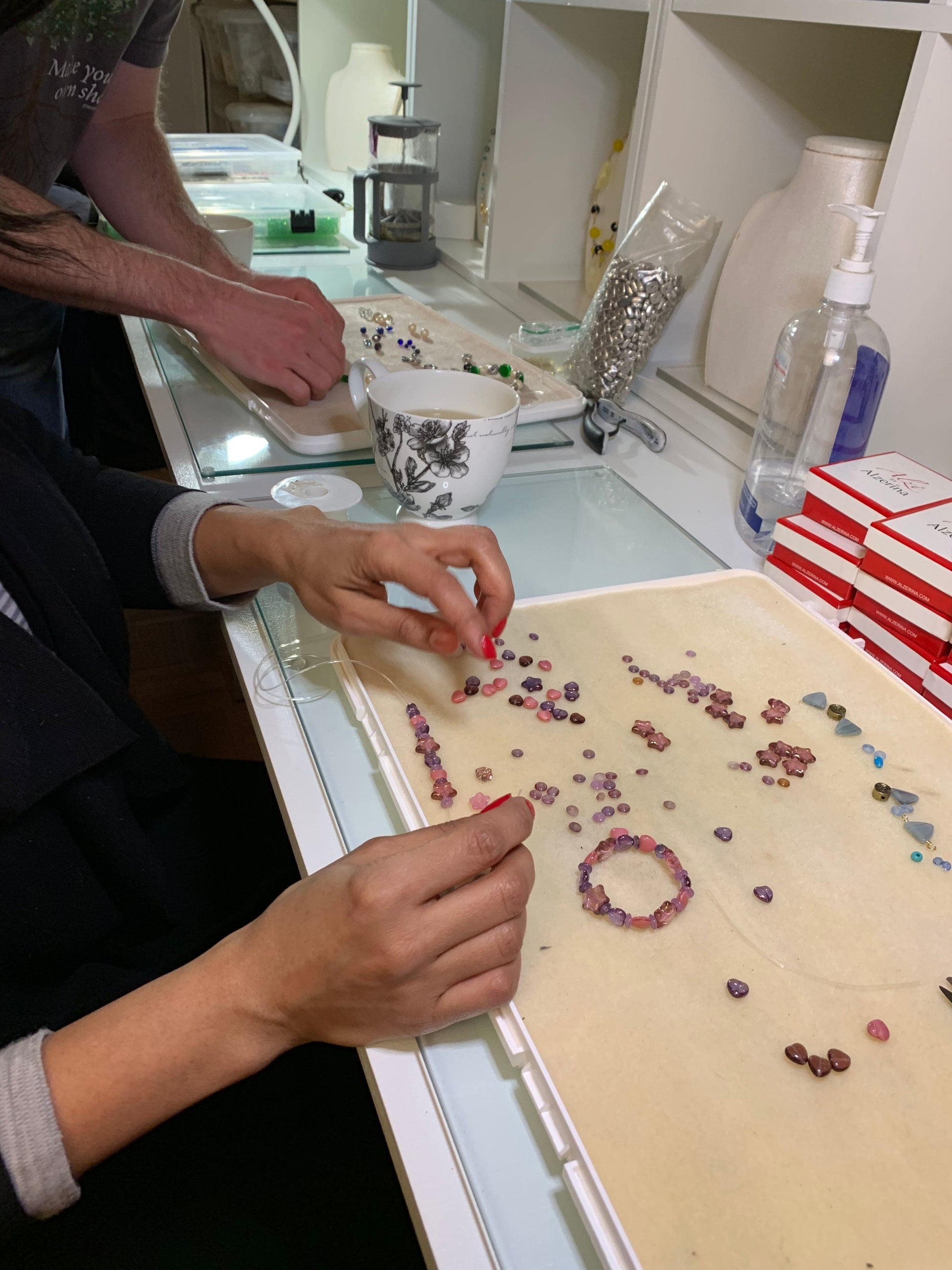 Small group practicing wire wrapping in hands-on jewelry making session