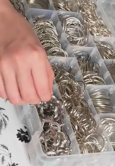 Hand selecting silver jewelry findings from DIY kit box – materials included in the Make Jewelry at Home class