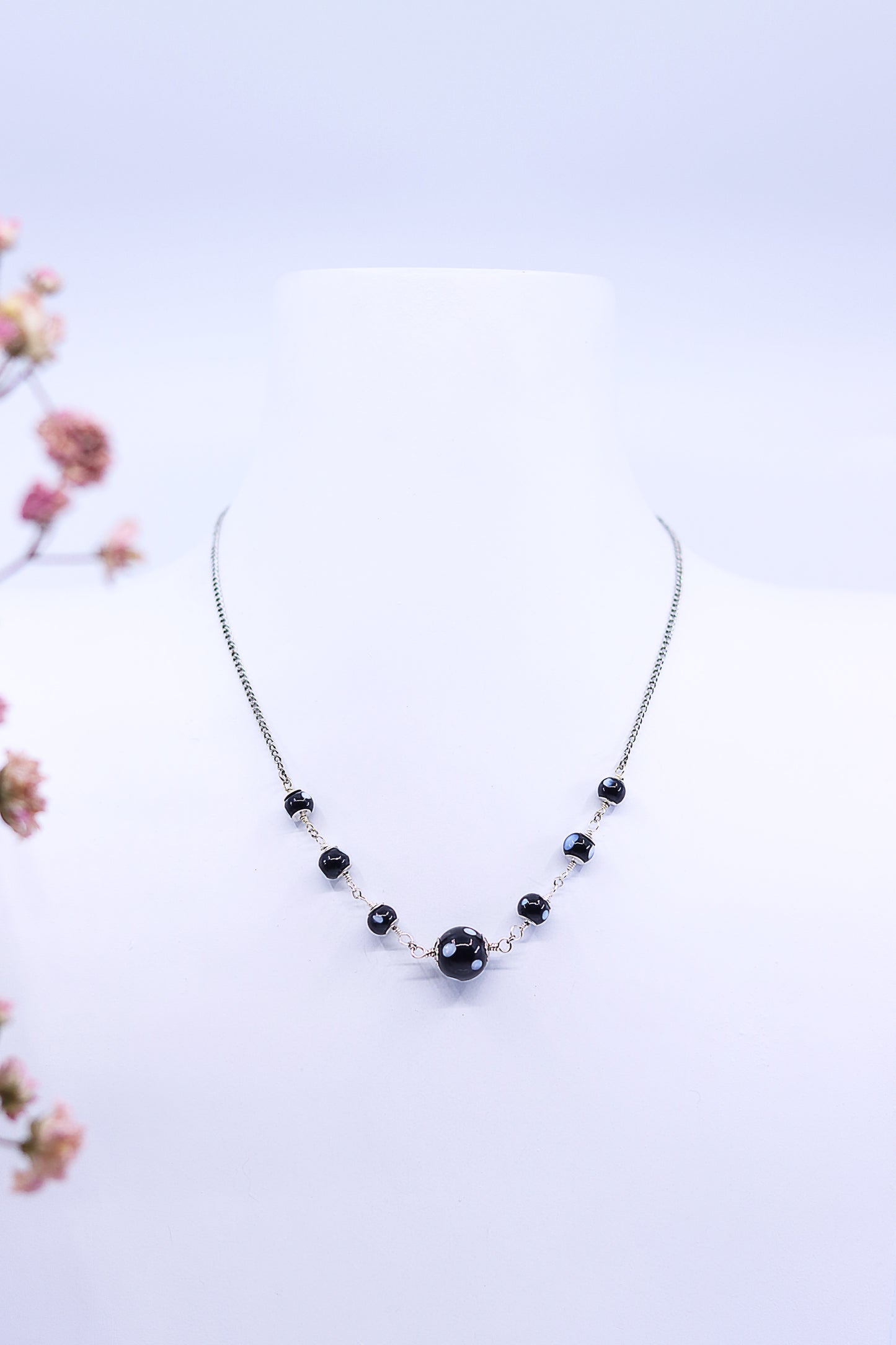 Gold-plated necklace with symmetrical Conta Di Ojo beads displayed on bust