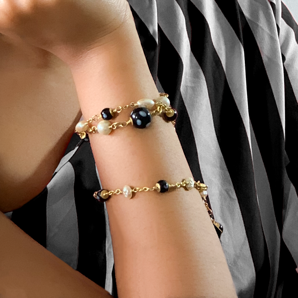 Gold and black Conta di Ojo evil eye bracelets handmade by Alzerina, inspired by Cape Verdean heritage for protection and style.
