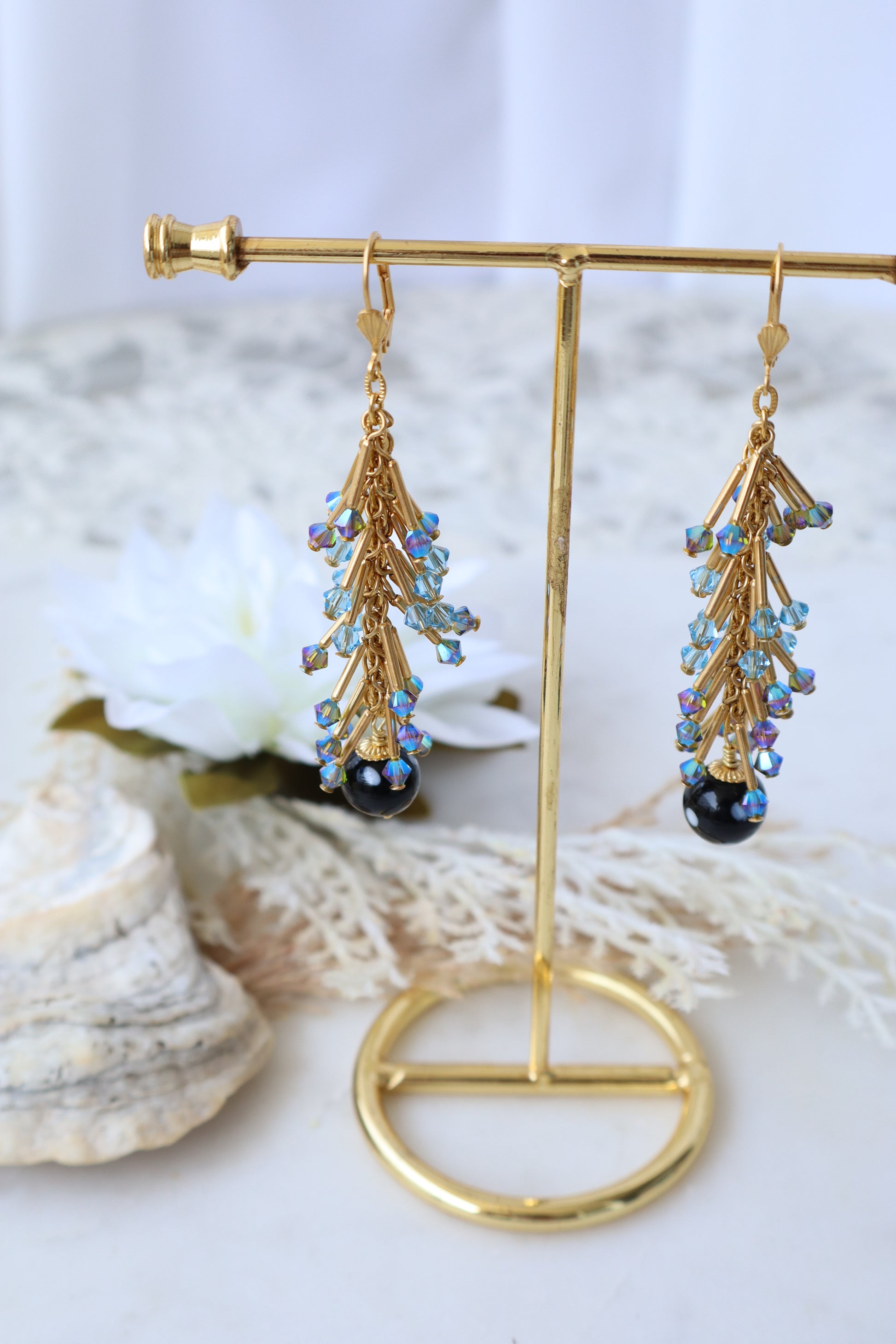 Gold brooches with gemstone details on a white background