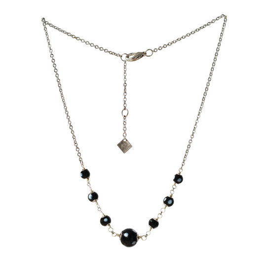 Necklace with black beads on a white background