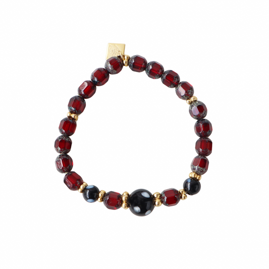 Bracelet with red and black beads on a white background