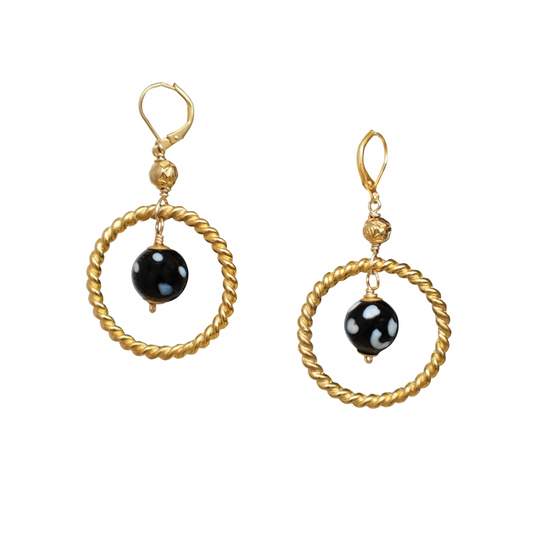 Gold hoop earrings with black beads on a white background