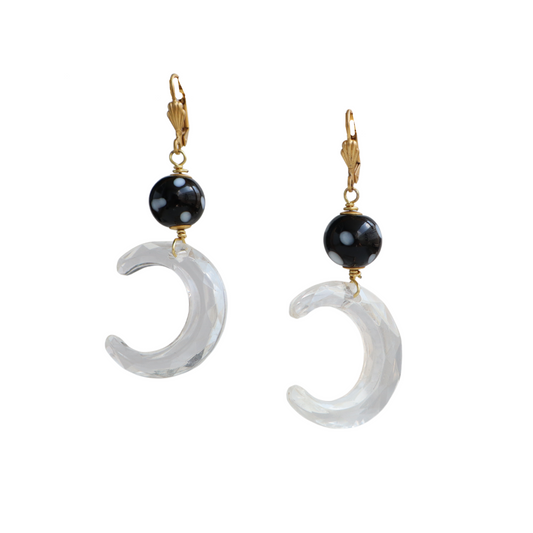 Pair of earrings with crescent moon shapes and black beads on a white background