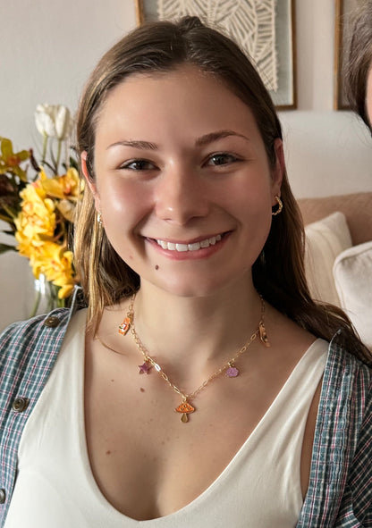 Girl smiling and wearing her handmade necklace
