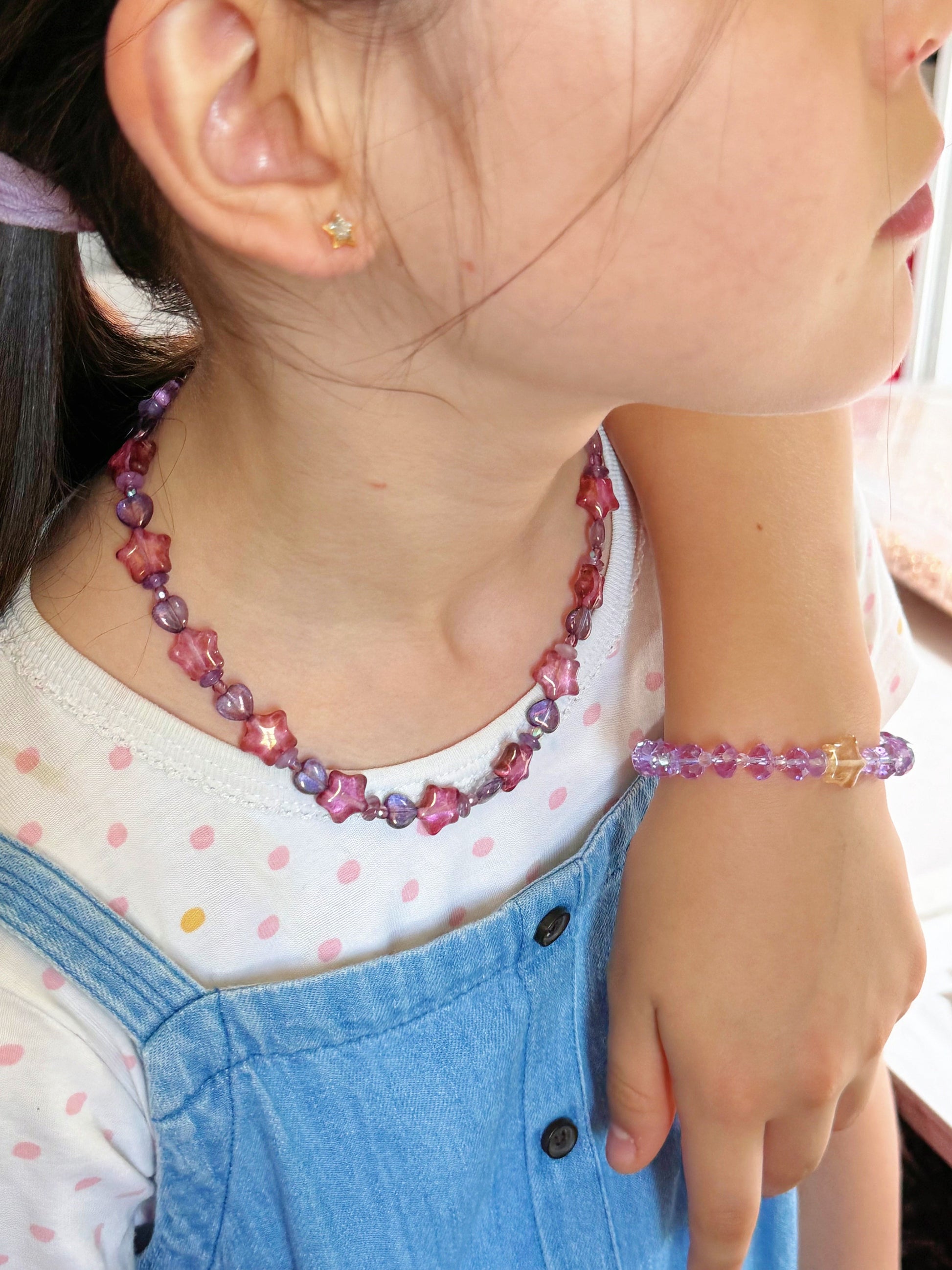 Young girl wearing her handmade necklace and bracelet set
