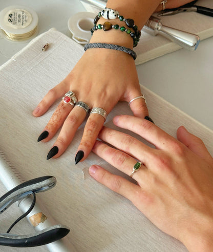 Student showing handmade rings created in a jewelry making workshop in NYC