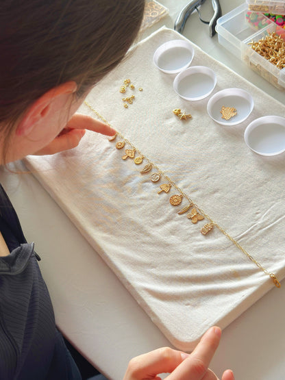 Student focused on assembling jewelry on workspace
