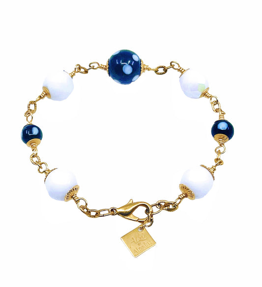 Features black and white evil eye beads (Conta Di Ojo) for protection and positivity