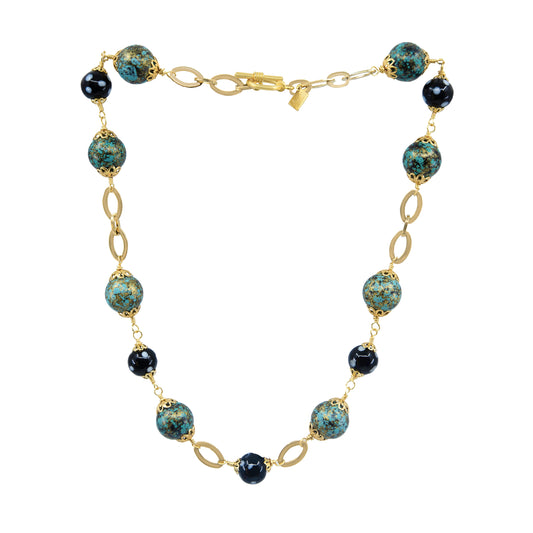 Front view of Alcidia Necklace with gold chain, turquoise and black Conta Di Ojo beads, handcrafted by Alzerina